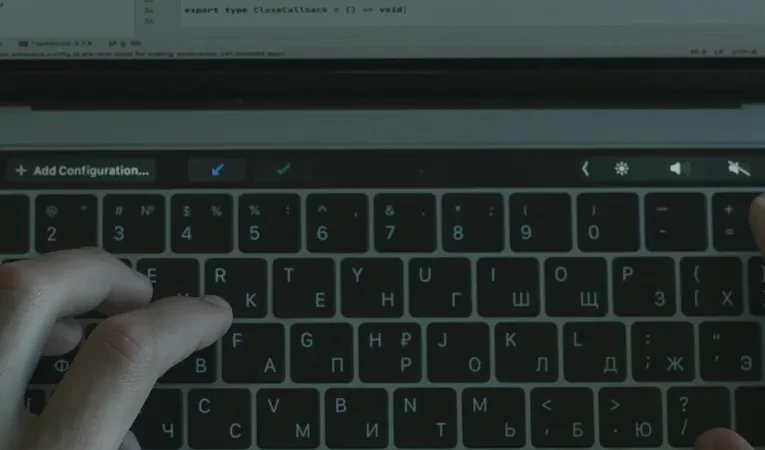 Hands typing code on a laptop, illustrating the Lovable AI security and legitimacy review