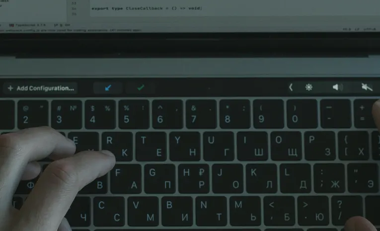 Hands typing code on a laptop, illustrating the Lovable AI security and legitimacy review