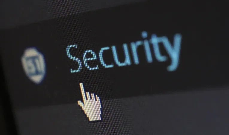 Mouse cursor over digital security text on a screen, illustrating browser extension safety checks