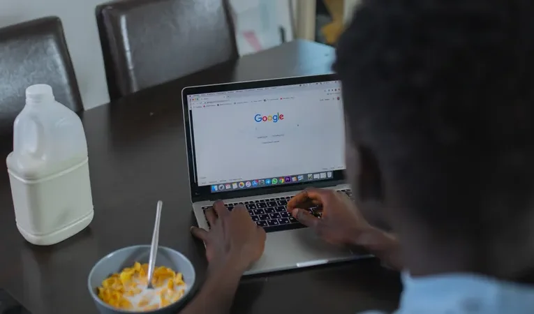 Person browsing on a laptop, illustrating fake Chrome update notification scams