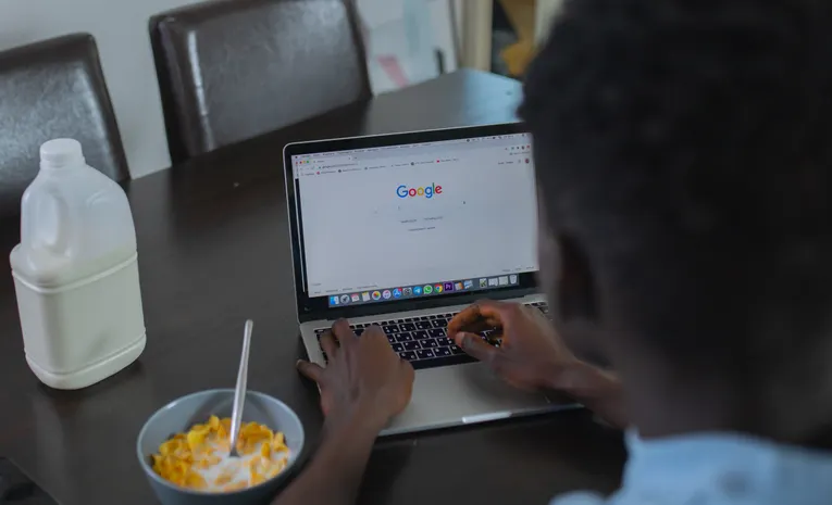 Person browsing on a laptop, illustrating fake Chrome update notification scams