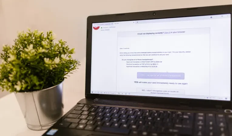 Laptop showing an email inbox interface on a desk, illustrating the Fyxer AI email assistant review