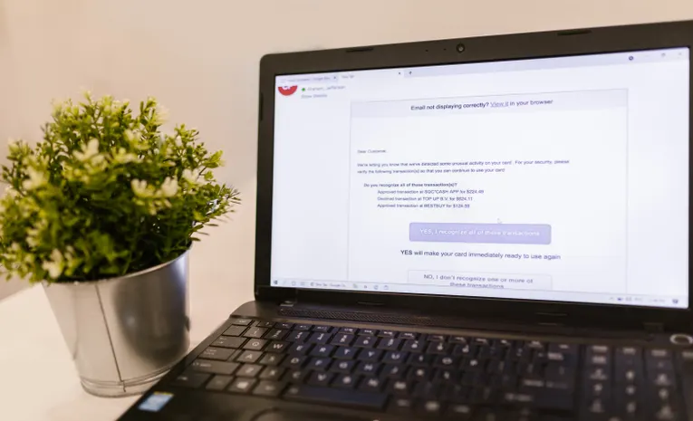 Laptop showing an email inbox interface on a desk, illustrating the Fyxer AI email assistant review