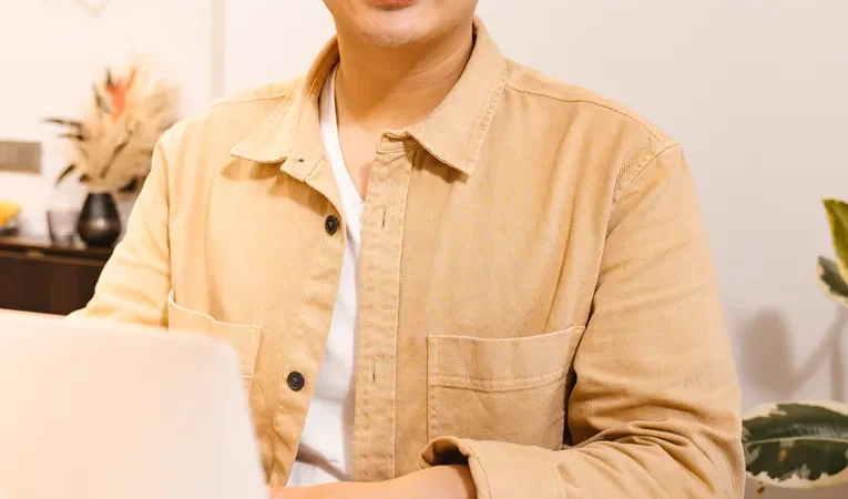 Person working on a laptop, illustrating the Genspark AI trust and legitimacy review