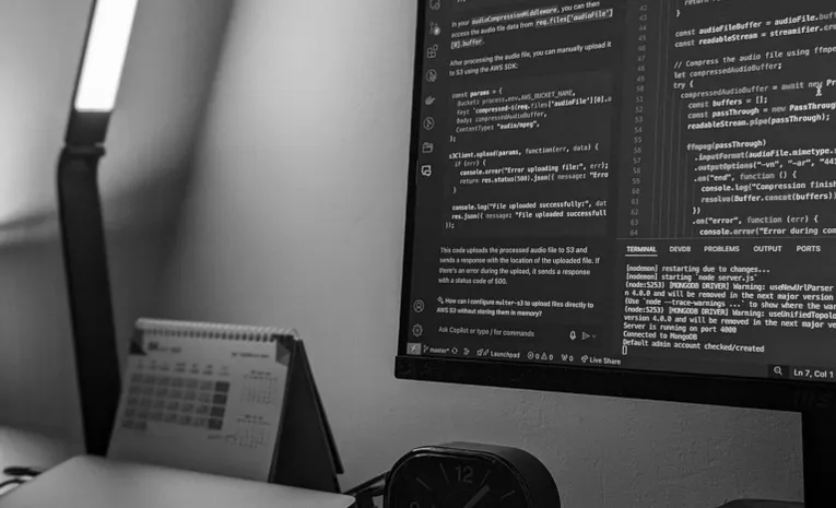 Software developer working with code on a monitor, illustrating the Replit Agent review