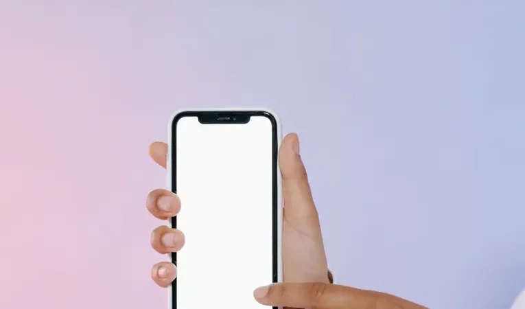 Person touching a mobile phone screen, illustrating the Rork AI mobile app builder review