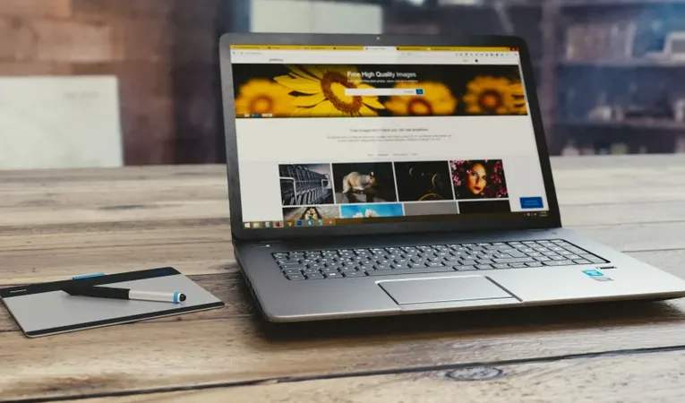 Laptop open on a desk showing a webpage, illustrating the Softr no-code app builder review