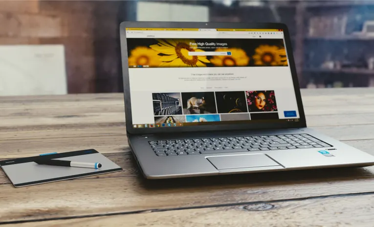 Laptop open on a desk showing a webpage, illustrating the Softr no-code app builder review