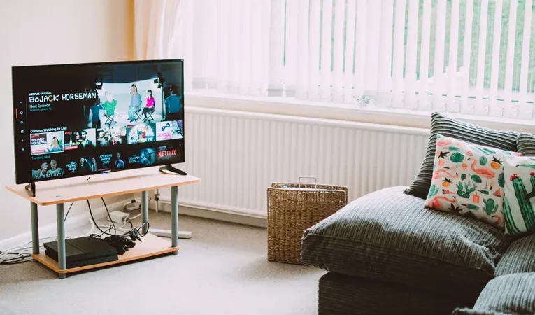 Smart TV playing content in a modern living room, illustrating ACR tracking and privacy settings