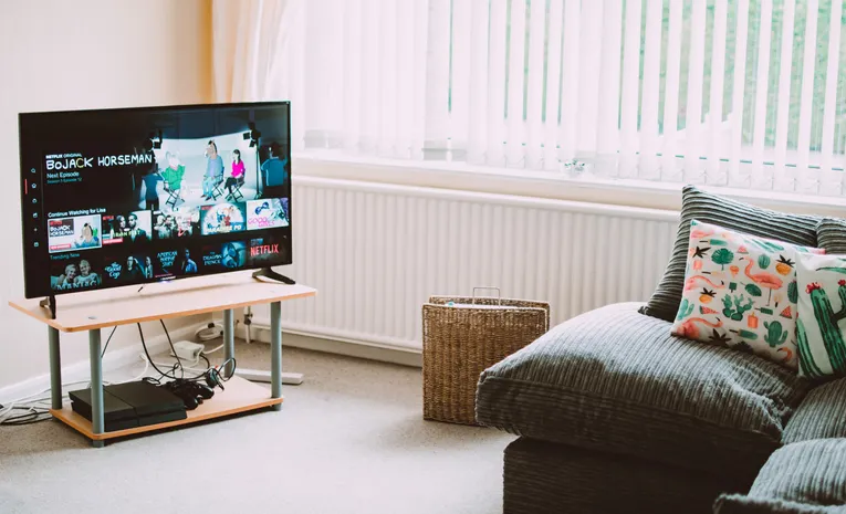 Smart TV playing content in a modern living room, illustrating ACR tracking and privacy settings