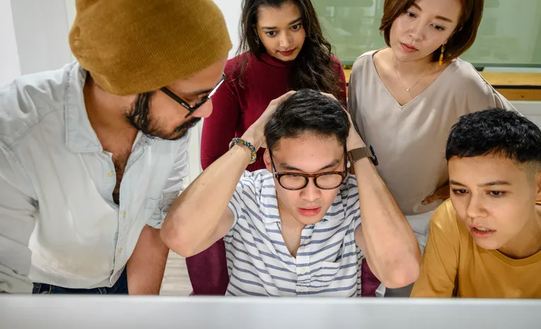 People looking concerned while viewing a computer screen, illustrating fake virus popup scareware alerts
